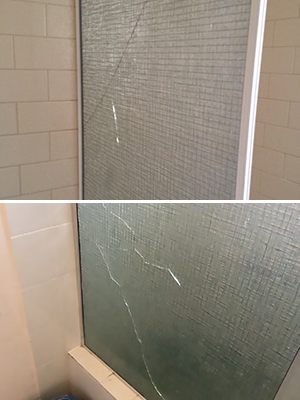 Heavily cracked top and bottom shower glass