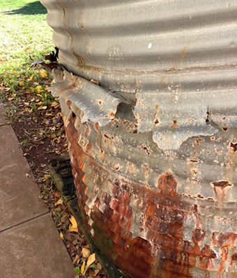 Rusted and collapsing rain water tank